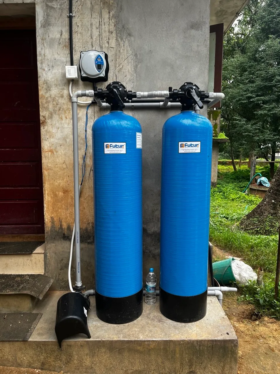 Completed Future Water Systems whole-house installation with twin FRP filtration vessels and an automatic control valve head in Thrissur, Kerala