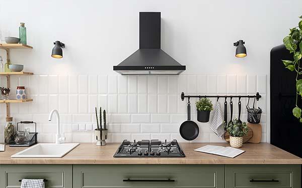 image of kitchen appliances like knives, sink counter top, utensils and light bulbs all arranged in an aesthetic way 