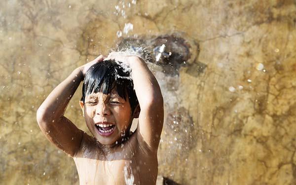 kid enjoying a lavish bath in the shower